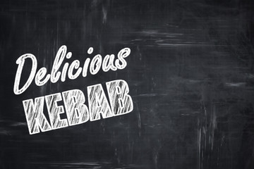 Chalkboard background with chalk letters: Delicious kebab sign