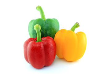 Green Red Yellow paprika peppers with water drops isolated on white background