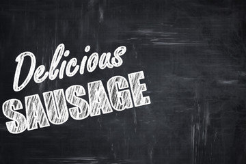Chalkboard background with chalk letters: Delicious sausage sign