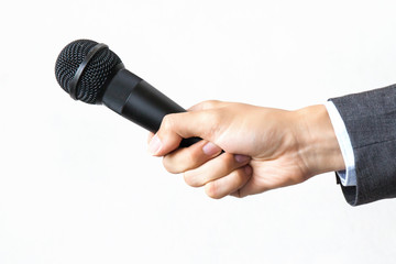 Male hand with microphone on isolated white background. Business and public speech concept