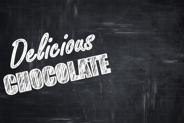 Chalkboard background with chalk letters: Delicious chocolate si