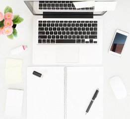 Office desk table with laptop, office supplies and flower pot