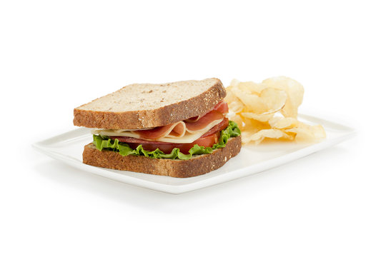 ham sandwich with cracker in white plate
