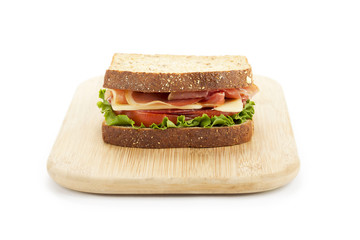 ham sandwich in wooden plate