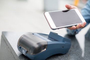 Woman using cellphone for payment