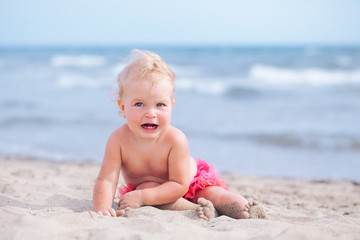 Little cute happy girl bathes in sea,  Italy, outdoor