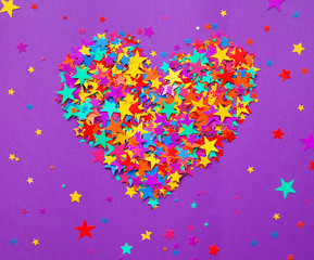 stars confetti on a purple background, a heart
