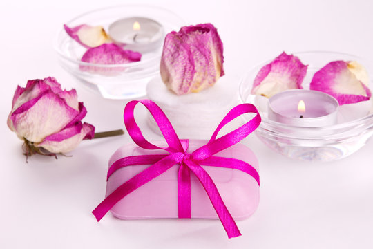 Soap with pink roses and candles for spa therapy