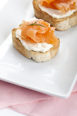 smoked salmon  and cream cheese on piece of bread