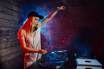 Cute dj woman having fun playing music at club party - obrazy, fototapety, plakaty