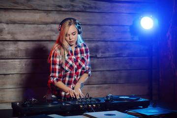 Cute dj woman having fun playing music at club party