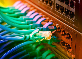 network cables and hub closeup with fiber optical background