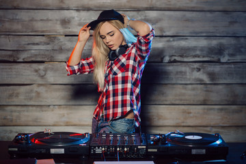 Cute dj woman having fun playing music at club party