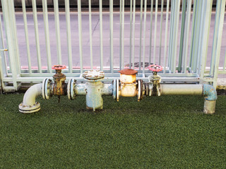 old metal rusty industrial tap water pipe and valve