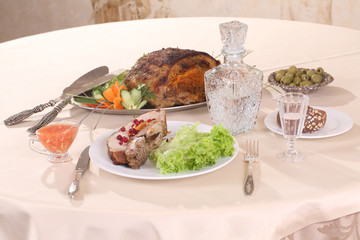 pork stuffed with vegetables and a decanter of vodka