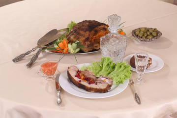 pork stuffed with vegetables and a decanter of vodka