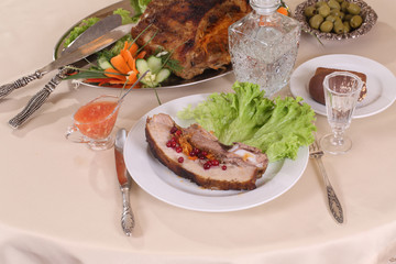 pork stuffed with vegetables and a decanter of vodka