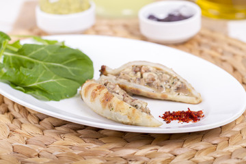 Plate of stuffed cuttlefish inside cheese, mushroom and seafood serving with aubergine salad
