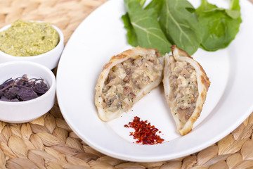 Plate of stuffed cuttlefish inside cheese, mushroom and seafood serving with aubergine salad