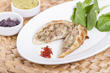 Plate of stuffed cuttlefish inside cheese, mushroom and seafood serving with aubergine salad