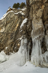 Fototapeta na wymiar Beautiful icicles on rocks. 