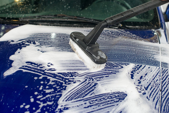 Car wash using special brush with soap.