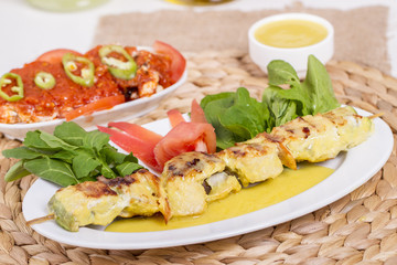 Whiting Fish Skewer on White Plate with Salad and Turkish Traditional Alcohol Drink Raki , Ouzo