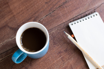 cup of coffee on wooden table closeup