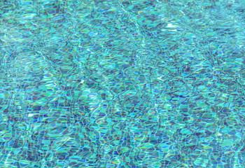 Blur blue ripple water in swimming pool background