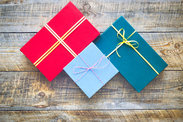 Fototapeta premium Colored gift boxes on wooden background