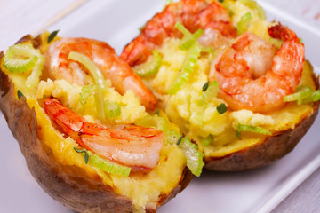 Stuffed potato with shrimps, celery, cheese and thyme