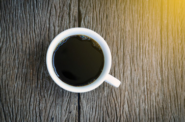 Coffee cup top view on  wooden background.