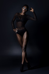 Fototapeta na wymiar Beautiful dark-skinned young woman sensualy posing in black ling