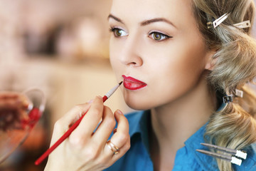 Make-up artist applying lipstick