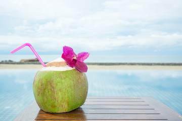 pool with artificial beach and tropical ocean