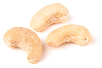 few cashew nuts on a white background close-up