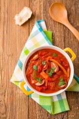 Delicious letcho with fresh vegetables, served in a yellow pot w