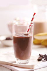 Glass of chocolate milk on table close-up