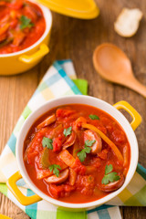 Delicious letcho with fresh vegetables, served in a yellow pot w