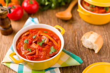 Delicious letcho with fresh vegetables, served in a yellow pot w