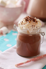Glass jar of chocolate milk on table close-up