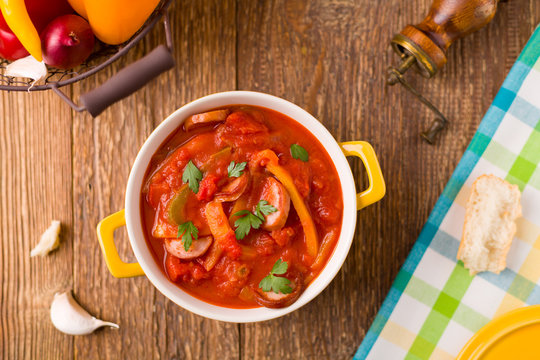 Delicious letcho with fresh vegetables, served in a yellow pot w