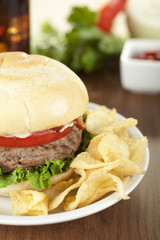 white plate with hamburger and chips