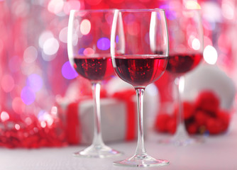 Wineglasses on red blurred lights background