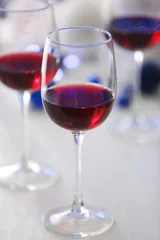 Fotobehang Wineglasses on blue blurred lights background © Africa Studio