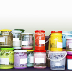 Many colorful ceramic glaze jars with white labels