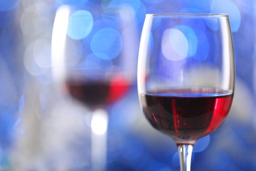 Wineglasses on blue blurred lights background