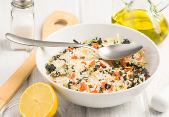 bowl with rice and dried seaweed before being cooked