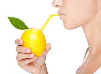 beautiful girl portrait  drink juice from a lemon isolated on white