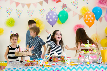 Obraz na płótnie Canvas Happy group of children dancing at birthday party